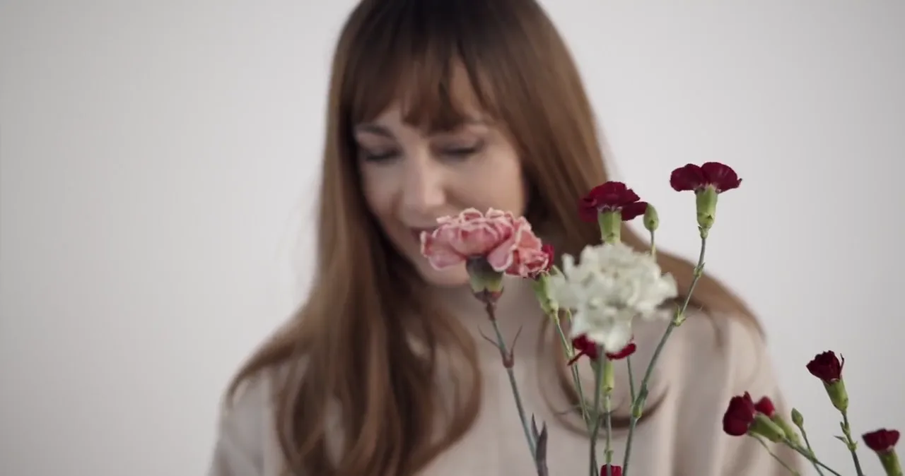 Representative still of a florist working with carnations